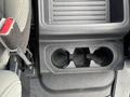 A cup holder compartment located in the center console of a 2017 Ford F-250 SD featuring two circular openings for drinks