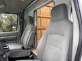 Interior of a 2024 Ford E-450 featuring two gray fabric seats with simple design and armrests
