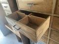 A wooden drawer from a Morgan Olson Workhorse W42 with compartments and a few coins inside