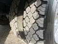 Close-up of a rugged tire on a 2012 Ford F-550 showcasing an intricate tread pattern designed for durability and traction