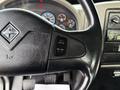 Close-up of the steering wheel of a 2011 International 4300 showing the cruise control buttons and the International logo on the wheel