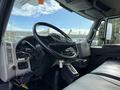 Interior view of a 2011 International 4300 truck featuring a large steering wheel dashboard controls and leather seats