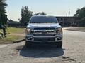A 2019 Ford F-150 pickup truck facing forward with a shiny white exterior and chrome accents on the grille and bumper