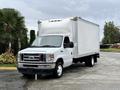 A white 2022 Ford E-450 box truck with a flat front and a closed cargo area is shown parked at an angle