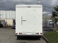 A white 2017 Freightliner MT45 box truck viewed from the rear with a smooth surface and distinctive latches and lights on the back