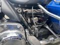 Close-up of a 2017 Harley-Davidson FLHTKL motorcycle's engine components showcasing the wiring and foot peg details