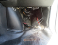 Interior view of a 2020 Chevrolet Express showing wiring and components underneath the dashboard near the driver's footwell