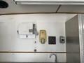 A 2008 Wells Industries Inc EW1422, featuring a stainless steel countertop with a soap dispenser and electrical outlets mounted on a white wall