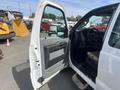 A 2014 Ford F-250 SD with the driver's side door open revealing the interior and dashboard