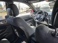 2015 Jeep Grand Cherokee interior featuring front seats and steering wheel with dashboard controls