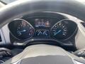 Dashboard of a 2015 Ford Escape displaying speedometer, tachometer, and various gauges with digital readouts in blue and white colors