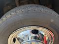 Close-up of a tire mounted on a chrome wheel with visible tread patterns and a portion of the wheel well of a 2011 Dodge Ram 5500