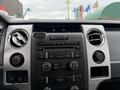 Dashboard of a 2014 Ford F-150 featuring control buttons air vents and a display panel