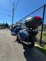 2016 Yamaha FJR1300AE motorcycle with a blue body and a top case attached parked on the ground