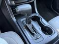Close-up of the gear shift and console of a 2018 GMC Canyon with a black leather-wrapped gear selector and P-R-N-D-L indicators visible