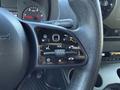 The steering wheel control panel of a 2023 Mercedes-Benz Sprinter 2500 featuring buttons for volume navigation and phone functions