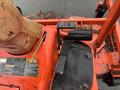 Close-up of the control panel and foot pedals of a 2010 Kubota F3680 lawn mower featuring orange and black colors and warning labels