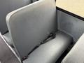 A gray bench seat with a seatbelt in a 2022 Freightliner B2
