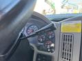 Close-up of the steering column in a 2013 International 7500 featuring a lever labeled not for parking and various dashboard gauges in the background