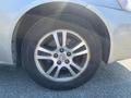 Close-up view of a silver 2006 Pontiac G6 wheel showcasing a five-spoke alloy rim with a tire mounted on it