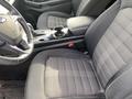 Interior of a 2017 Ford Edge showing black fabric seats with a checkered pattern and a center console featuring a gear shifter and cup holders