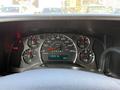 The dashboard of a 2017 Chevrolet Express showing speedometer fuel gauge and temperature gauge with various warning lights illuminated