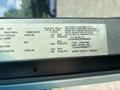 A 2012 Ford E-450 vehicle identification sticker displaying tire pressure, rim size, and manufacturing details