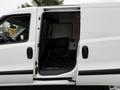 A 2017 RAM ProMaster City van with the side door open revealing a spacious interior with black flooring and walls