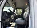 Interior view of a 2019 Freightliner M2 106 showcasing the driver's seat dashboard and controls