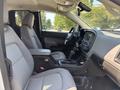 Interior view of a 2017 Chevrolet Colorado showing the driver's seat, center console, and dashboard with controls and display