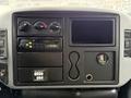 Dashboard of a 2006 International 4200 with control knobs a radio display and a gauge with a circular dial