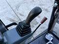 A close-up view of the control lever of a 2023 Sany SY35U excavator with a black textured grip and a secondary lever beside it