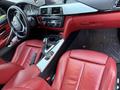 Interior view of a 2016 BMW 4-Series Gran Coupe featuring red leather seats and a modern dashboard with a navigation display and central control console