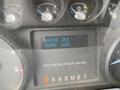 Dashboard display of a 2015 Ford F-550 showing engine idle status with hours logged as 2223 and warning lights for turbo and engine functions