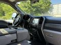 Interior view of a 2019 Ford F-550 featuring a black dashboard with touchscreen controls and a steering wheel with controls
