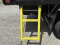 A yellow ladder attached to the back of a 2017 Ford F-550 truck