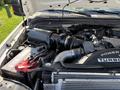 Close-up of a 2008 Ford F-550 engine featuring a black air intake and turbocharger components with visible wiring and battery connections