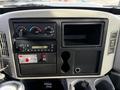 Dashboard of a 2012 International DuraStar 4300 featuring gauges a stereo system and storage compartments