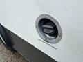 Close-up of a fuel cap on a 2018 Chevrolet Express with the label unleaded fuel only visible