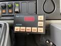 Control panel of a 2013 International Durastar 4300 featuring various buttons including AUX DIMMER and indicators for LEFT CENTER RIGHT FLASH and FAST