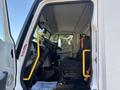 Interior view of a 2022 Lion Lion6 truck showing the driver's seat dashboard and steering wheel with a yellow safety bar and floor mat stating thank you for your service