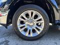A close-up of a shiny chrome wheel on a 2015 RAM 1500 with a black tire featuring the word DURATRAK embossed on the side