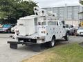 A 2018 Ford F-550 bucket truck with a utility bed and an elevated boom lift for reaching high areas