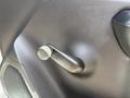 Close-up of the door handle of a 2016 Chevrolet Silverado 2500HD showing a textured black surface and a metallic grip for adjusting the window