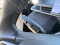 Close-up of the turn signal stalk in a 2023 Fisker Ocean featuring various controls for indicators and headlights
