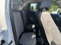 Interior view of a 2017 Chevrolet Colorado showing rear seats with light gray upholstery and seat belts