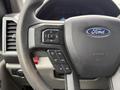 Steering wheel of a 2019 Ford F-350 SD featuring control buttons for settings and navigation
