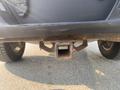 A close-up view of the rear hitch receiver on a 2016 Ford F-150 showing rust and wear