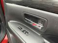 Close-up of the interior door panel of a 2016 Mitsubishi Outlander featuring a door handle and window control buttons