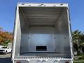 Empty cargo area of a 2011 Freightliner M2 106 truck with a silver metallic interior and a black loading ramp